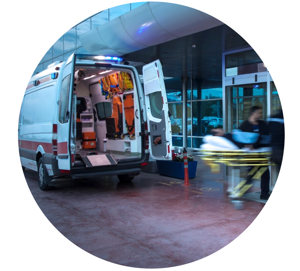 Ambulance parked, with patient being rushed into the hospital